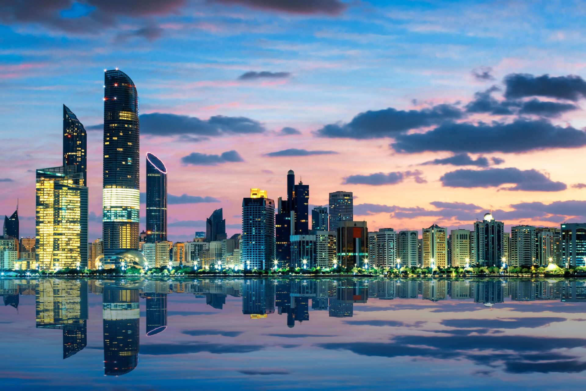 Abu Dhabi from sea view, showing towers and sea with clouds at sunset